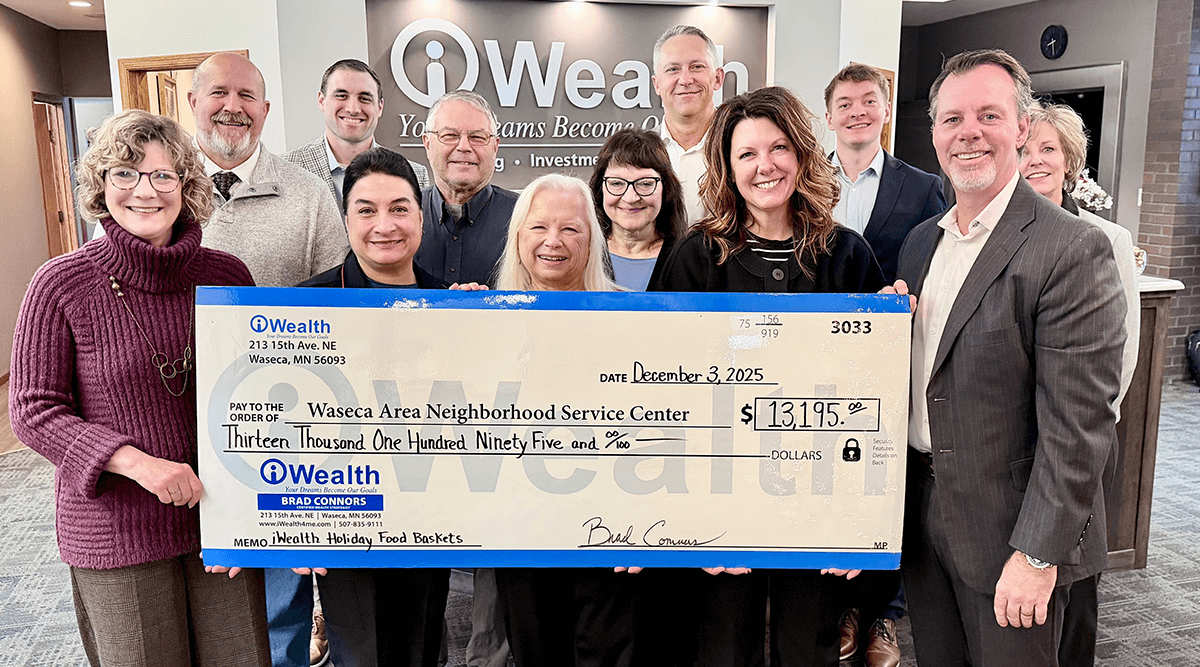 The iWealth team presents a check to the Waseca Area Neighborhood Service Center to provide food for local families and students