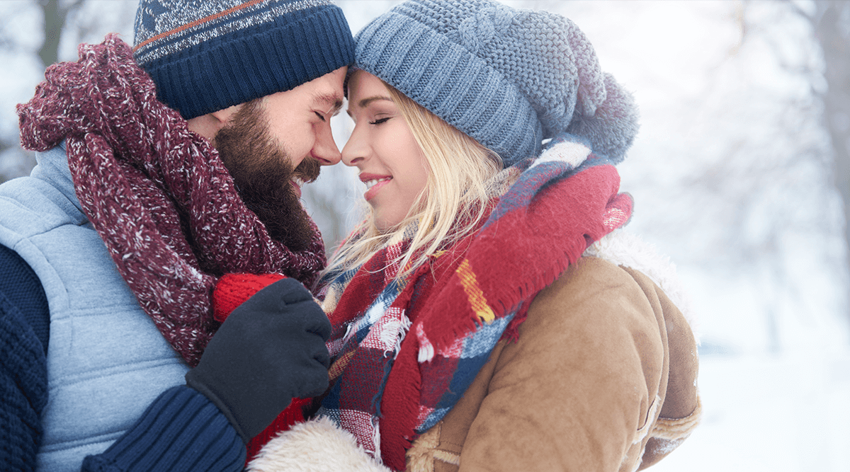 Happy couple walking in the snow
