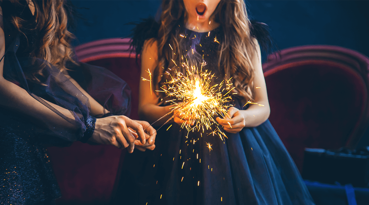 Girl in blue dress celebrates New Years Eve